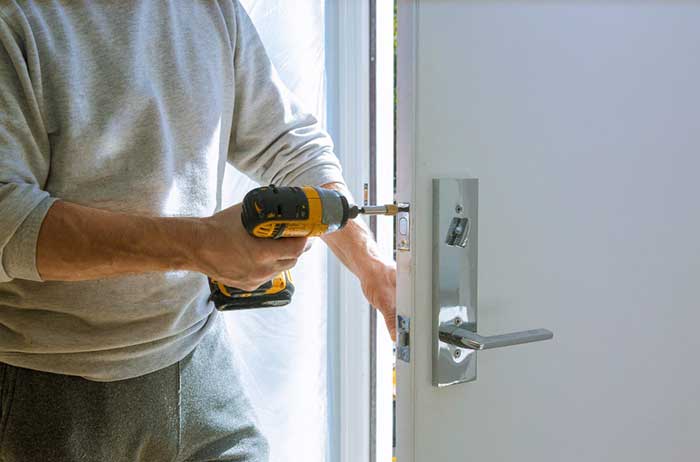 Drill driver installing lock in Door