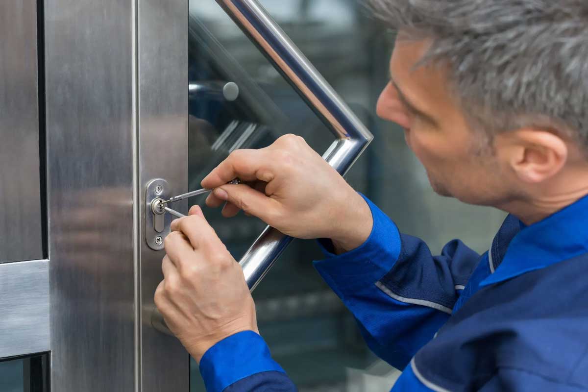locksmith using picks on a commercial door lock